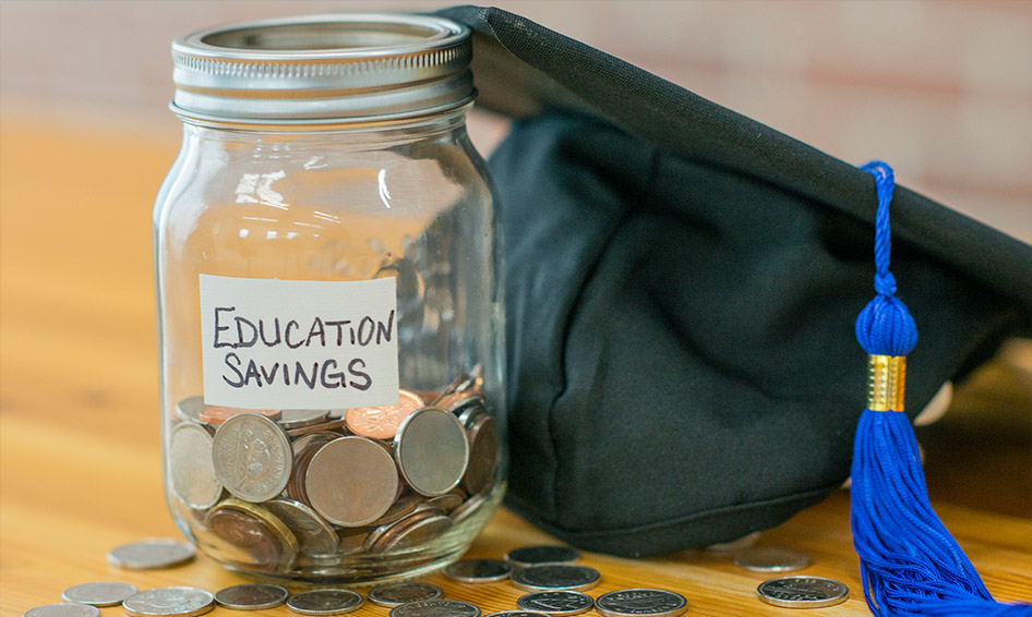 A clear, glass jar filled with change and twenty dollar bills. The jar has a yellow label and the word College written across it. The text The Future is written beneath it on a mint green background.
